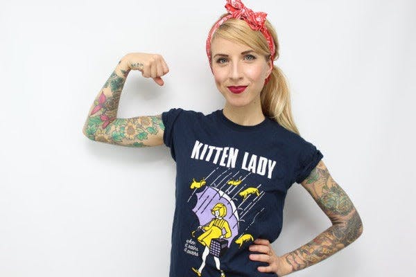 a woman in a t - shirt with a tattoo on her arm